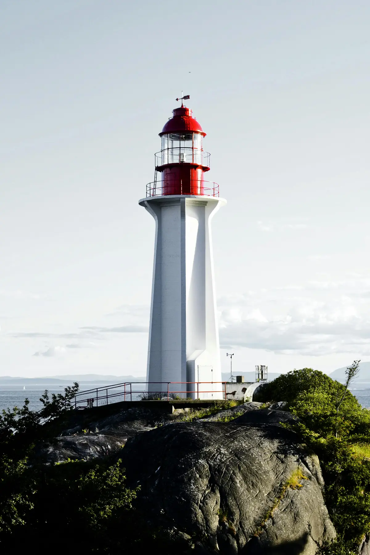 Beautiful lighthouse standing on the rocky shore of West Vancouver with scenic ocean backdrop.